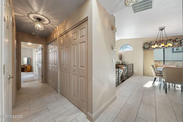 a view of a room with furniture and chandelier