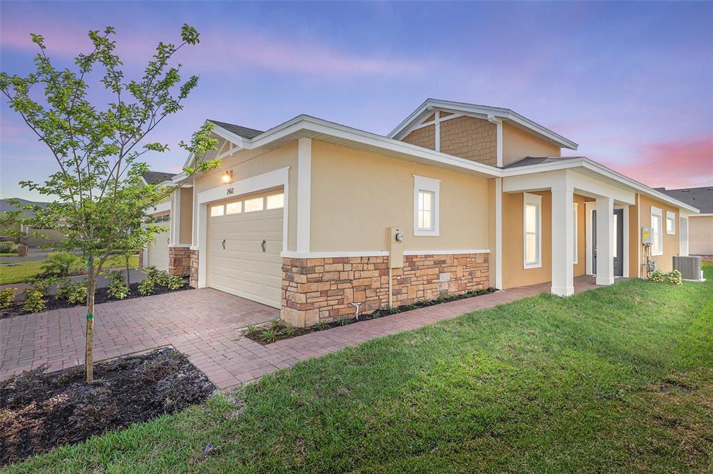 2462 Model Lane St. Cloud, FL 34772 - Photo 1 of 1 a front view of a house with a garden