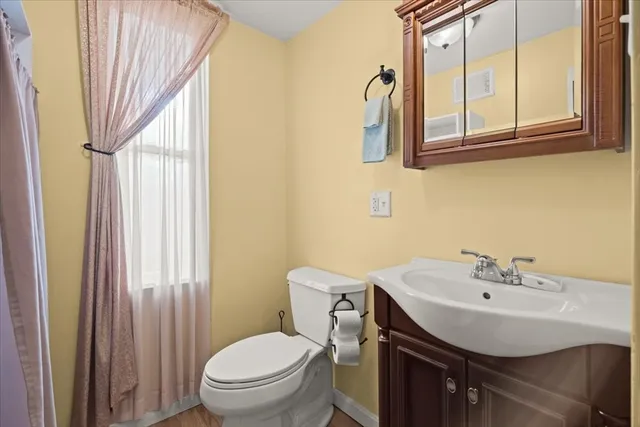 a bathroom with a sink a toilet and a mirror