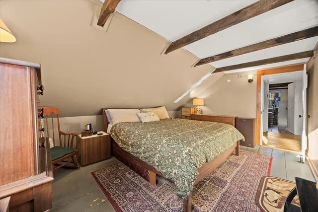 a bedroom with a bed and a mirror