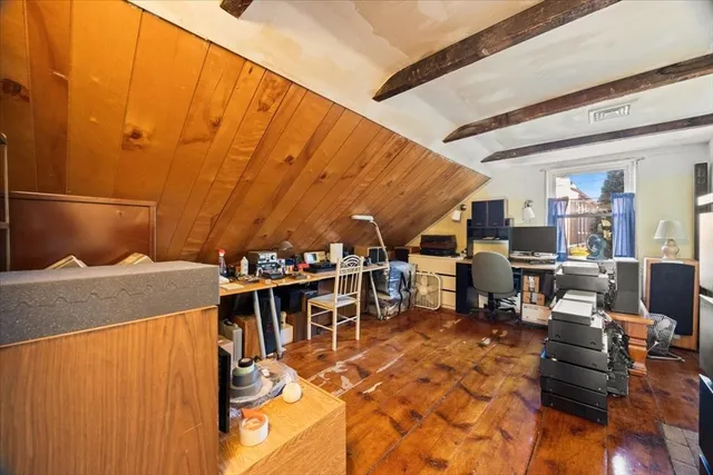 a view of a big room with dining table chairs and a kitchen view