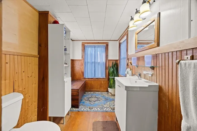 a bathroom with a sink mirror vanity and toilet