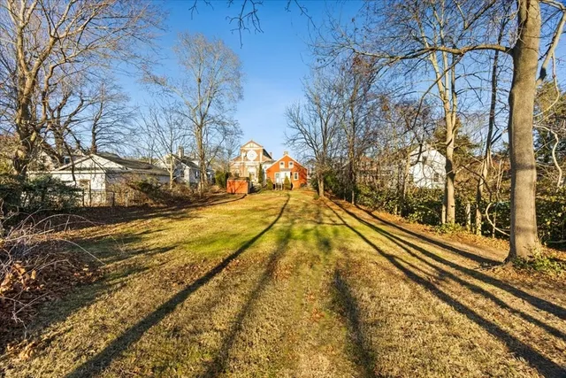 a view of a yard with wooden fence