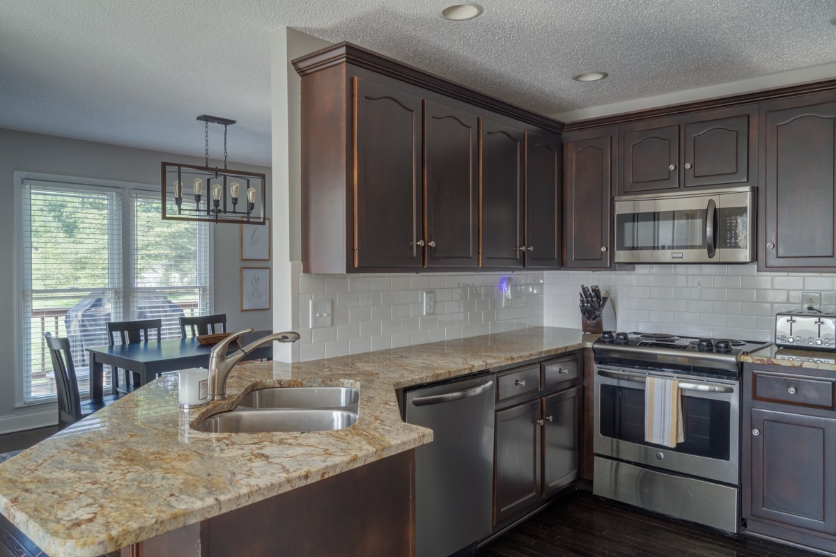 883 South Ridge Trail Clarksville, TN 37043 - Photo 9 of 42 The kitchen is open to the windows and eating nook and open to the dining room. It also has timeless subway tile surround