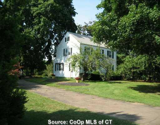 734 Ridge Road Orange, CT 06477 - Photo 1 of 1 a front view of house with yard and green space