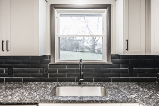 a bathroom with a sink and a window