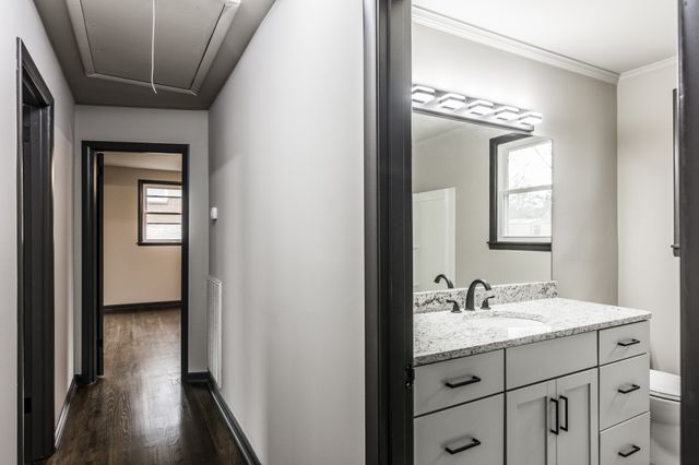 a bathroom with a double vanity sink and a mirror