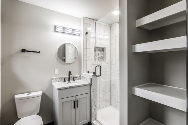 a bathroom with a toilet sink and a mirror