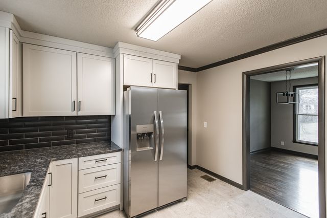 a kitchen with appliances cabinets and a counter top space