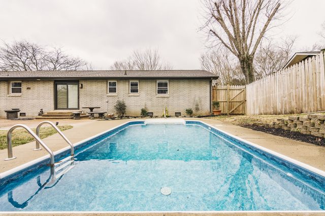 a view of a backyard with a sink and a fire pit