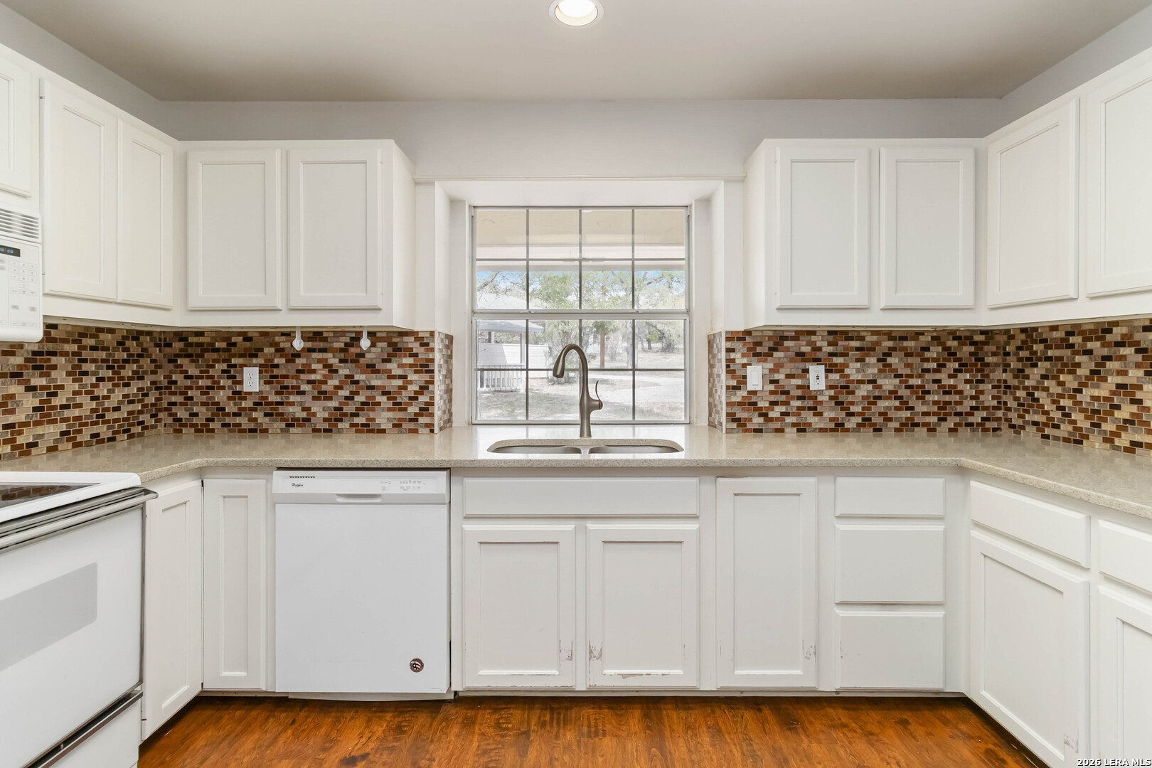 31949 Oak Ridge Parkway Bulverde, TX 78163 - Photo 12 of 50 a kitchen with white cabinets and a sink