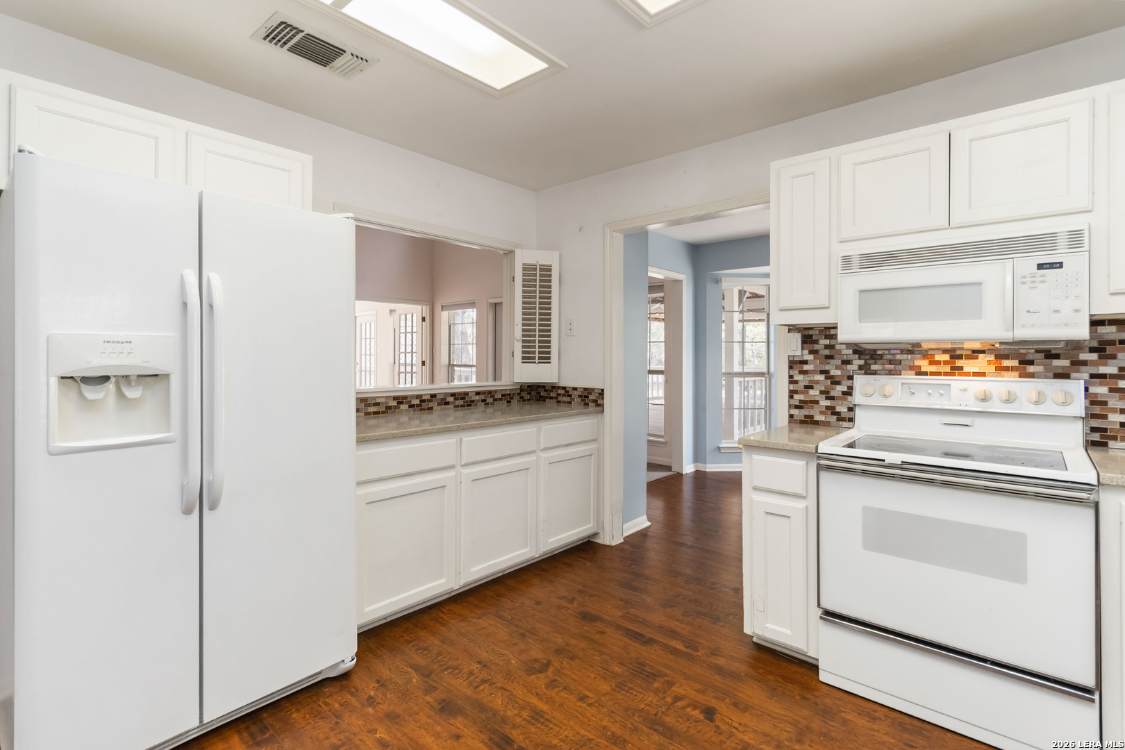 31949 Oak Ridge Parkway Bulverde, TX 78163 - Photo 14 of 50 a kitchen with white cabinets and white appliances