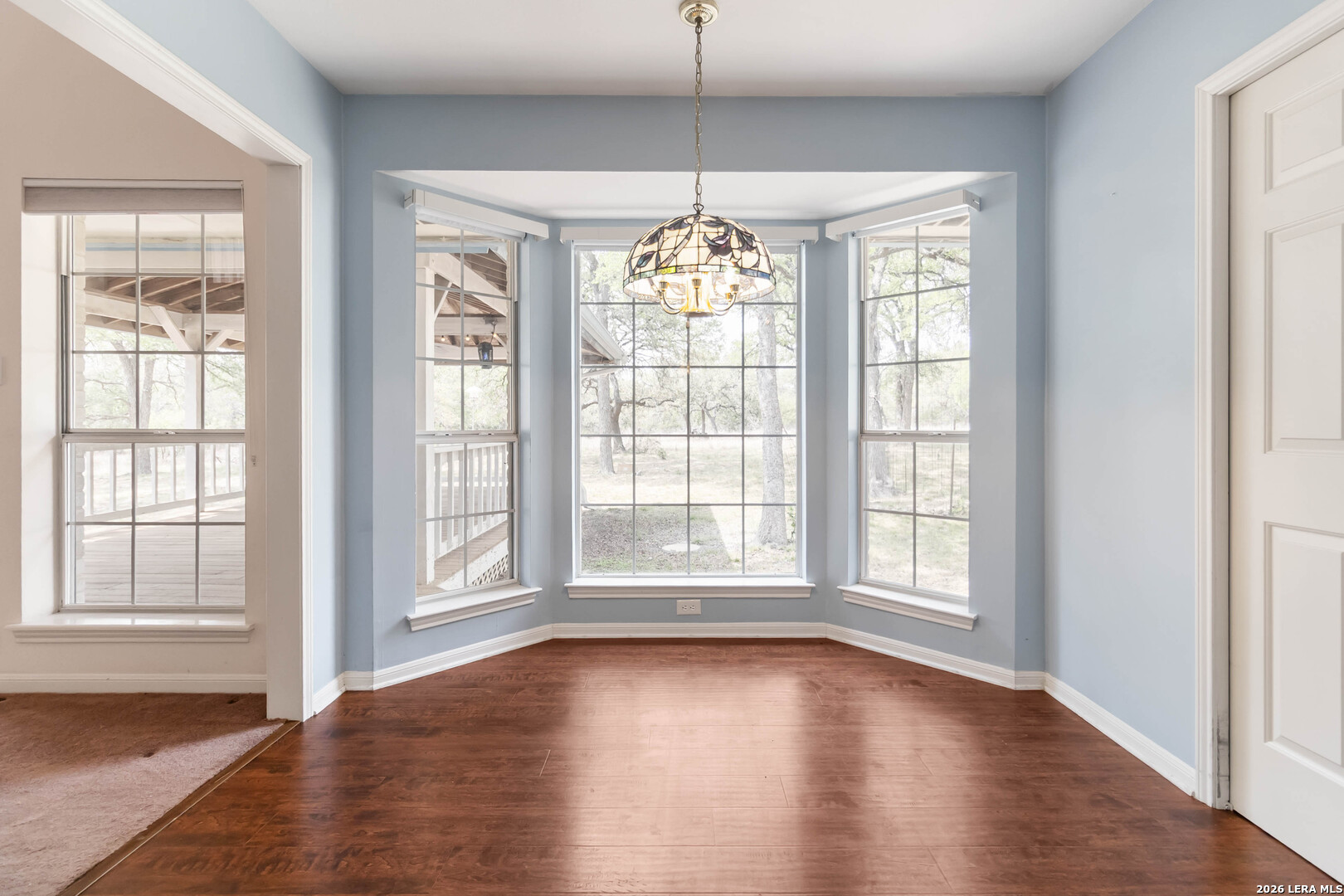 31949 Oak Ridge Parkway Bulverde, TX 78163 - Photo 15 of 50 an empty room with wooden floor and windows