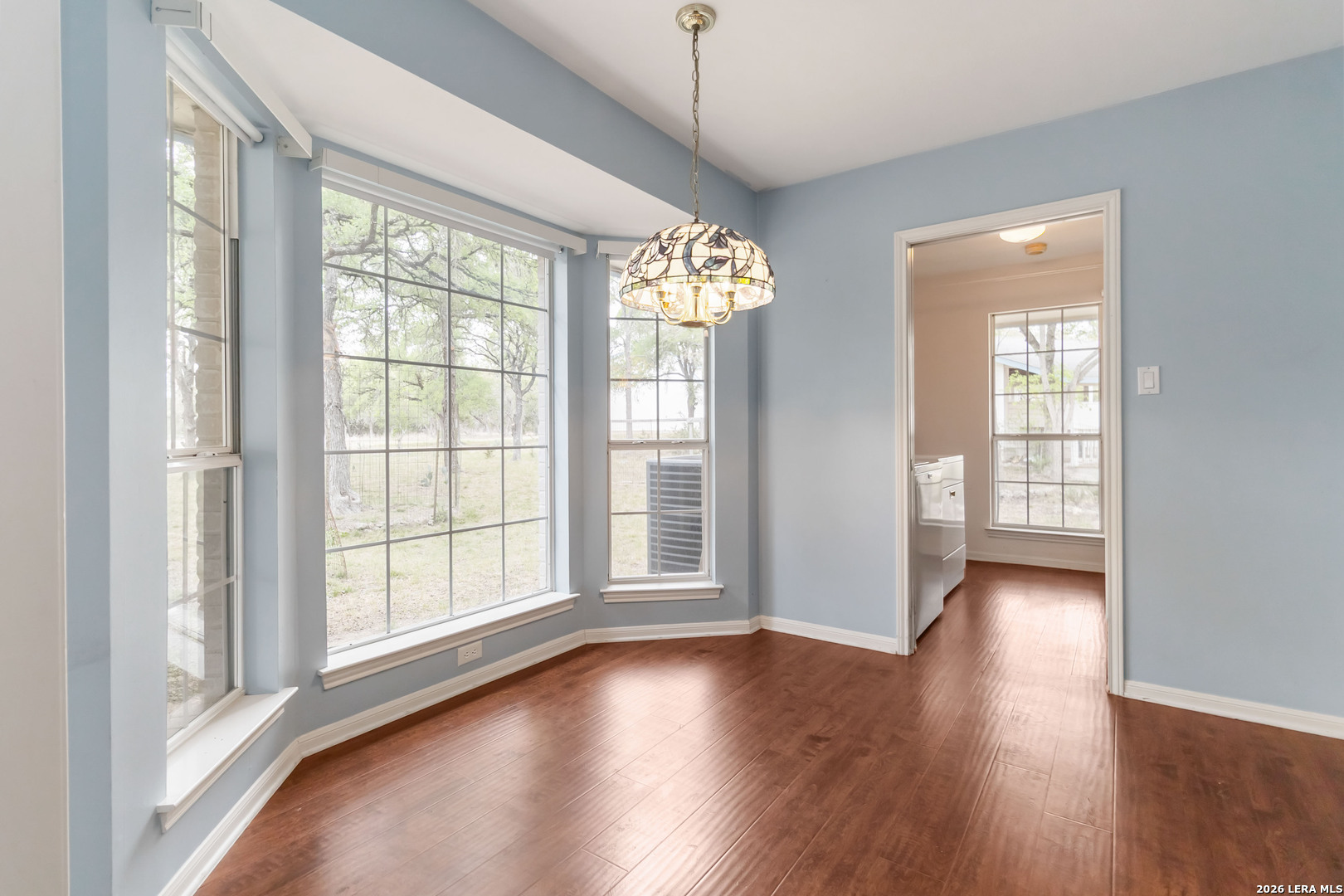 31949 Oak Ridge Parkway Bulverde, TX 78163 - Photo 16 of 50 an empty room with wooden floor and windows