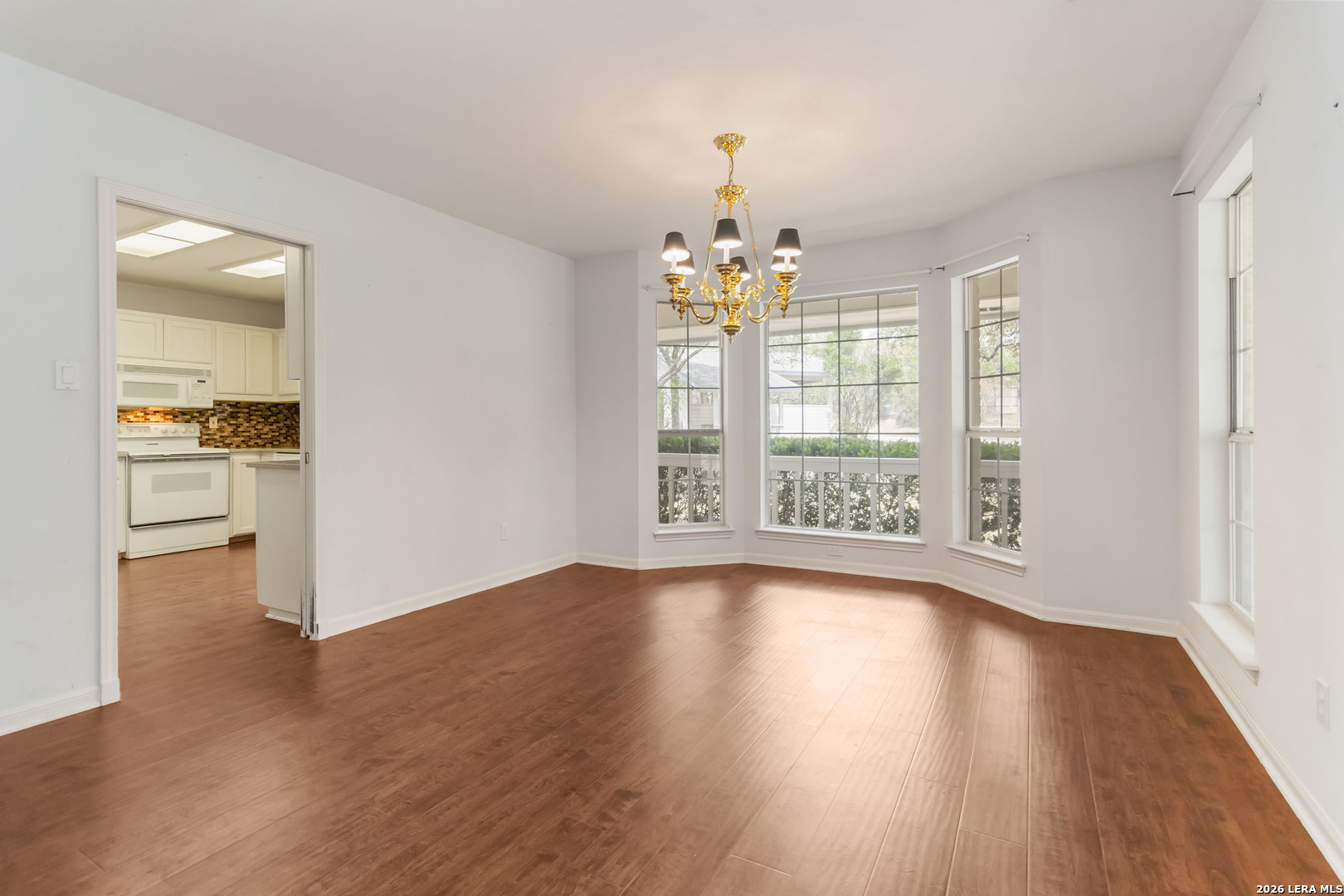 31949 Oak Ridge Parkway Bulverde, TX 78163 - Photo 17 of 50 a view of an empty room with wooden floor and a window