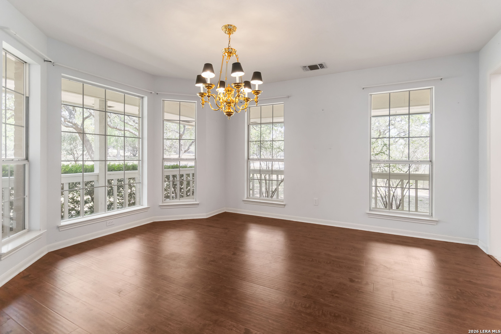 31949 Oak Ridge Parkway Bulverde, TX 78163 - Photo 18 of 50 a view of an empty room with wooden floor and a window