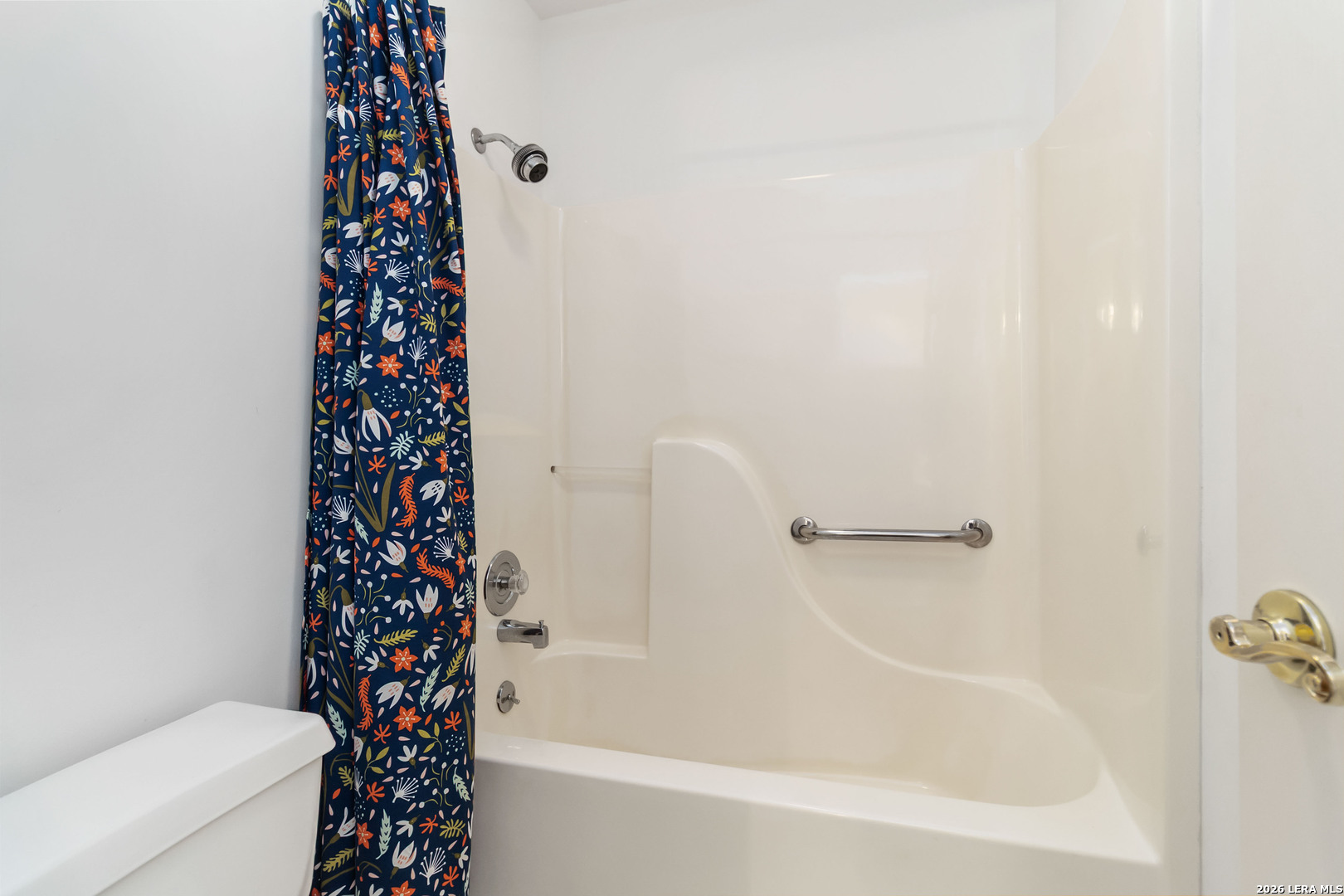 31949 Oak Ridge Parkway Bulverde, TX 78163 - Photo 31 of 50 a bathroom with a shower curtain and a toilet