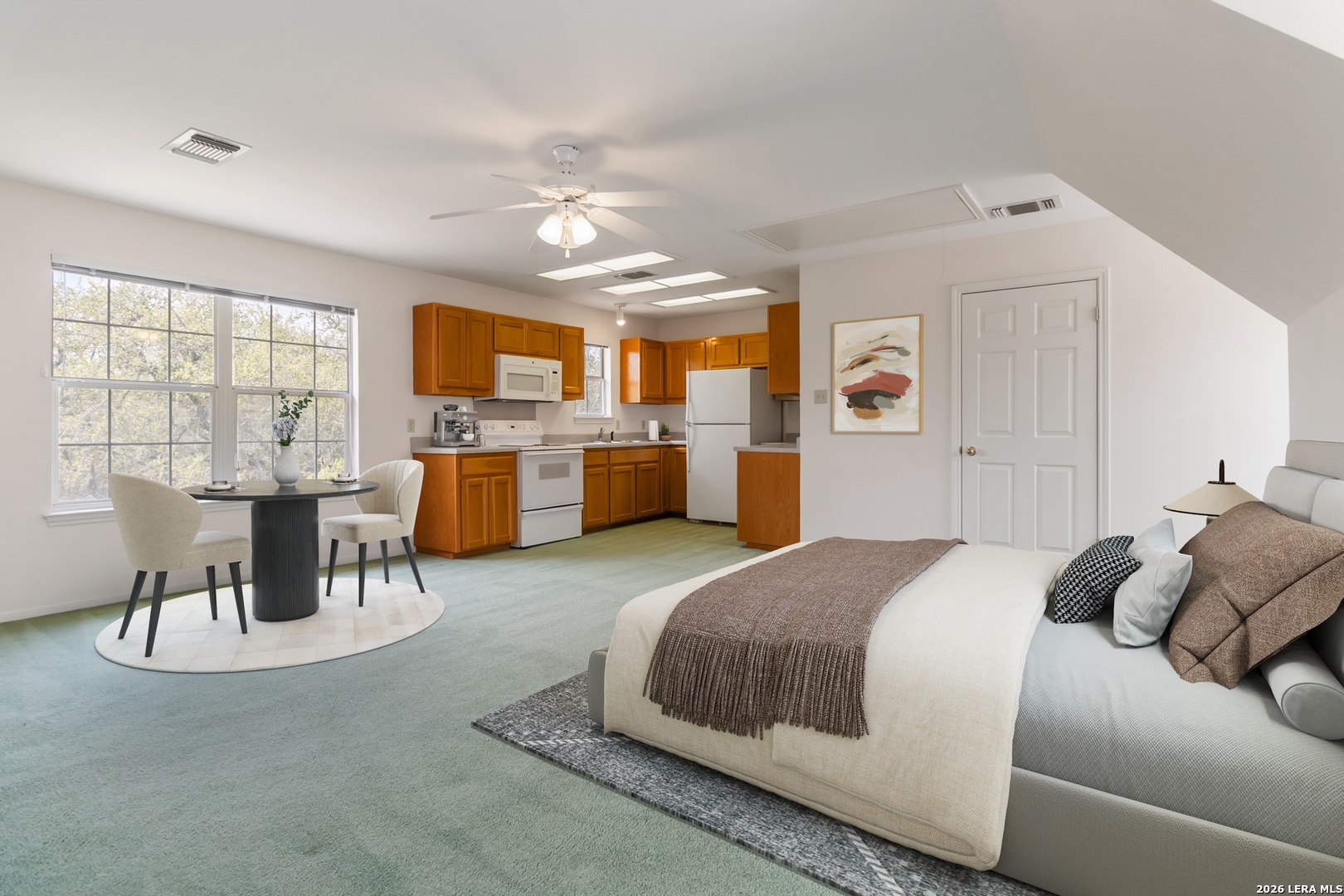 31949 Oak Ridge Parkway Bulverde, TX 78163 - Photo 38 of 50 a spacious bedroom with a bed and wooden cabinets