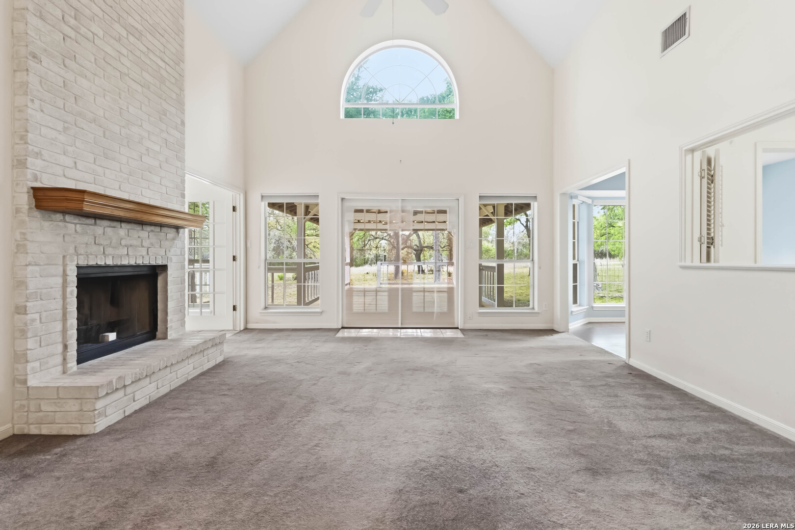 31949 Oak Ridge Parkway Bulverde, TX 78163 - Photo 4 of 50 an empty room with windows and fireplace