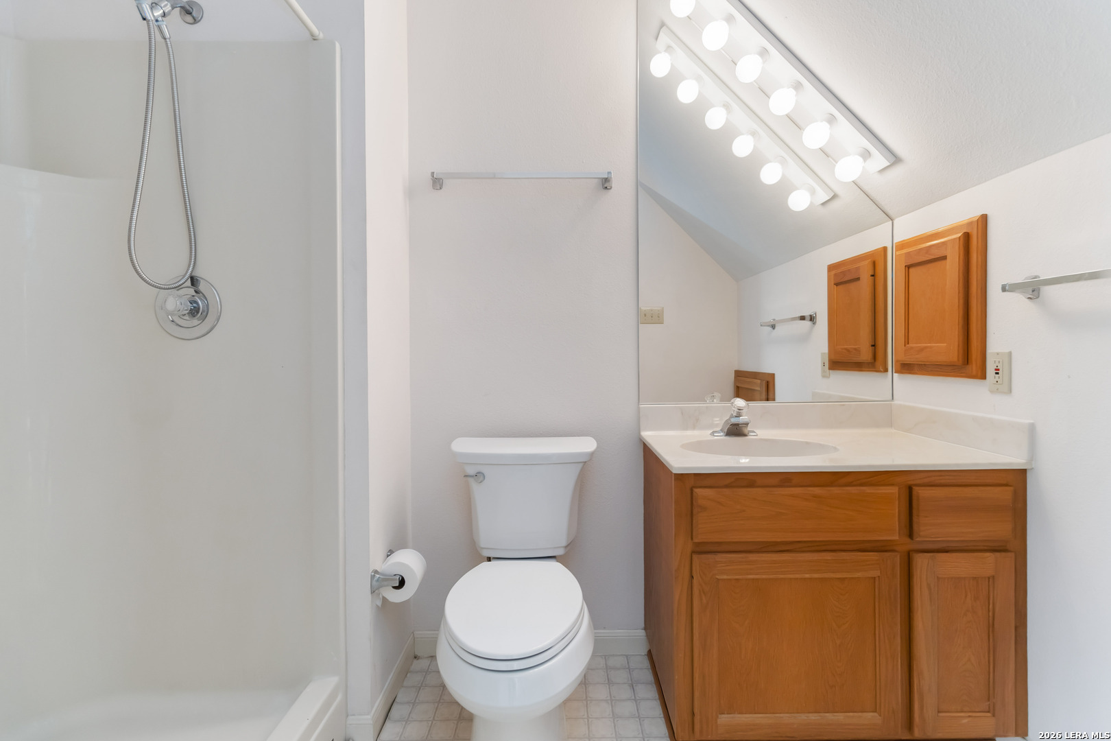 31949 Oak Ridge Parkway Bulverde, TX 78163 - Photo 41 of 50 a bathroom with a toilet sink vanity and mirror