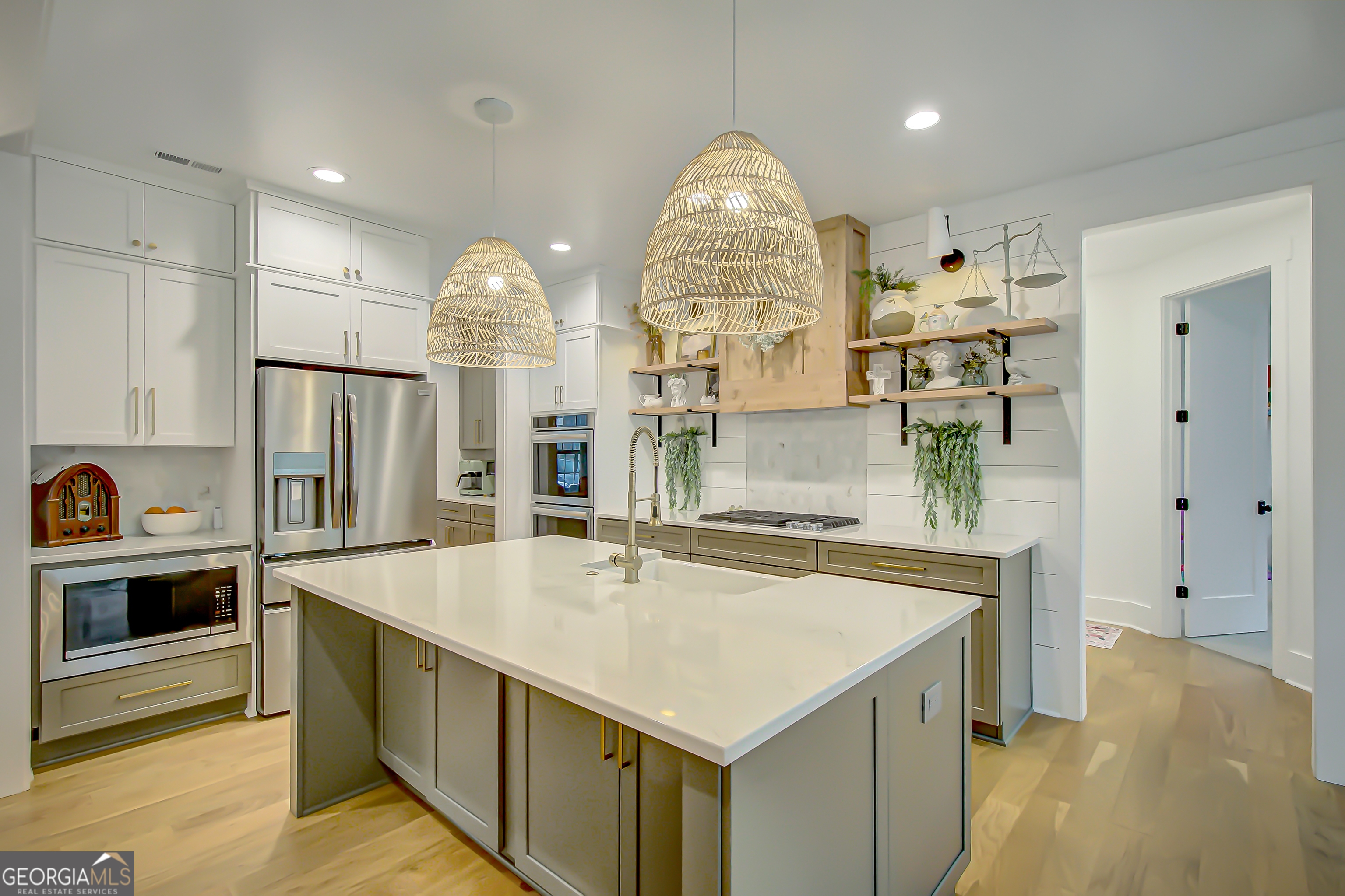 140 South Alexander Creek Road Newnan, GA 30263 - Photo 16 of 67 a large kitchen with stainless steel appliances a large counter top and a fireplace