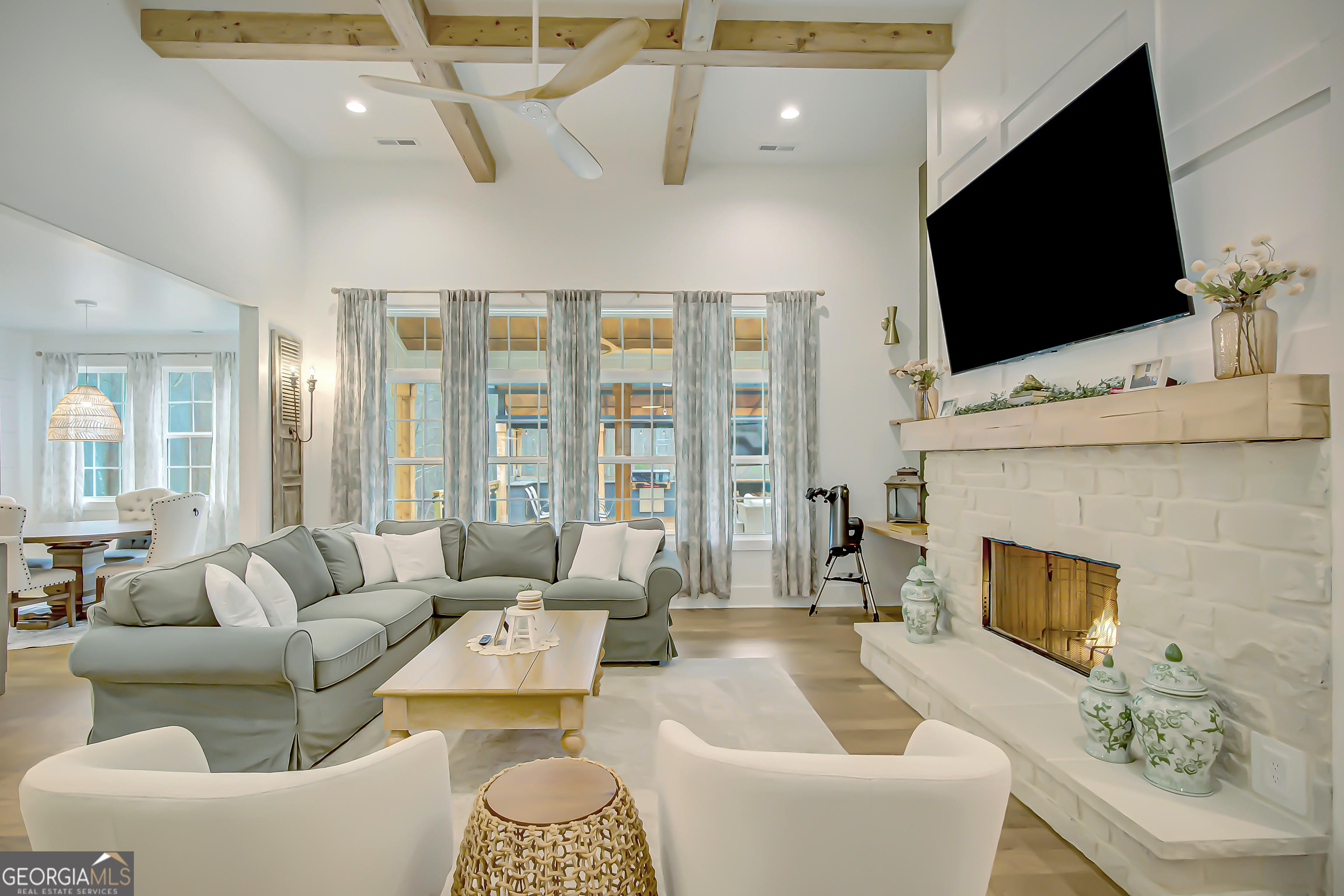 140 South Alexander Creek Road Newnan, GA 30263 - Photo 9 of 67 a living room with furniture a flat screen tv and a fireplace