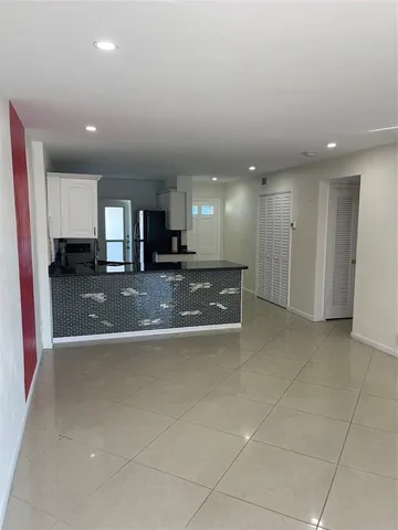 a view of a kitchen with a sink and cabinets