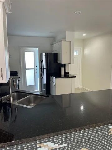 a kitchen with a sink and large stainless steel appliances