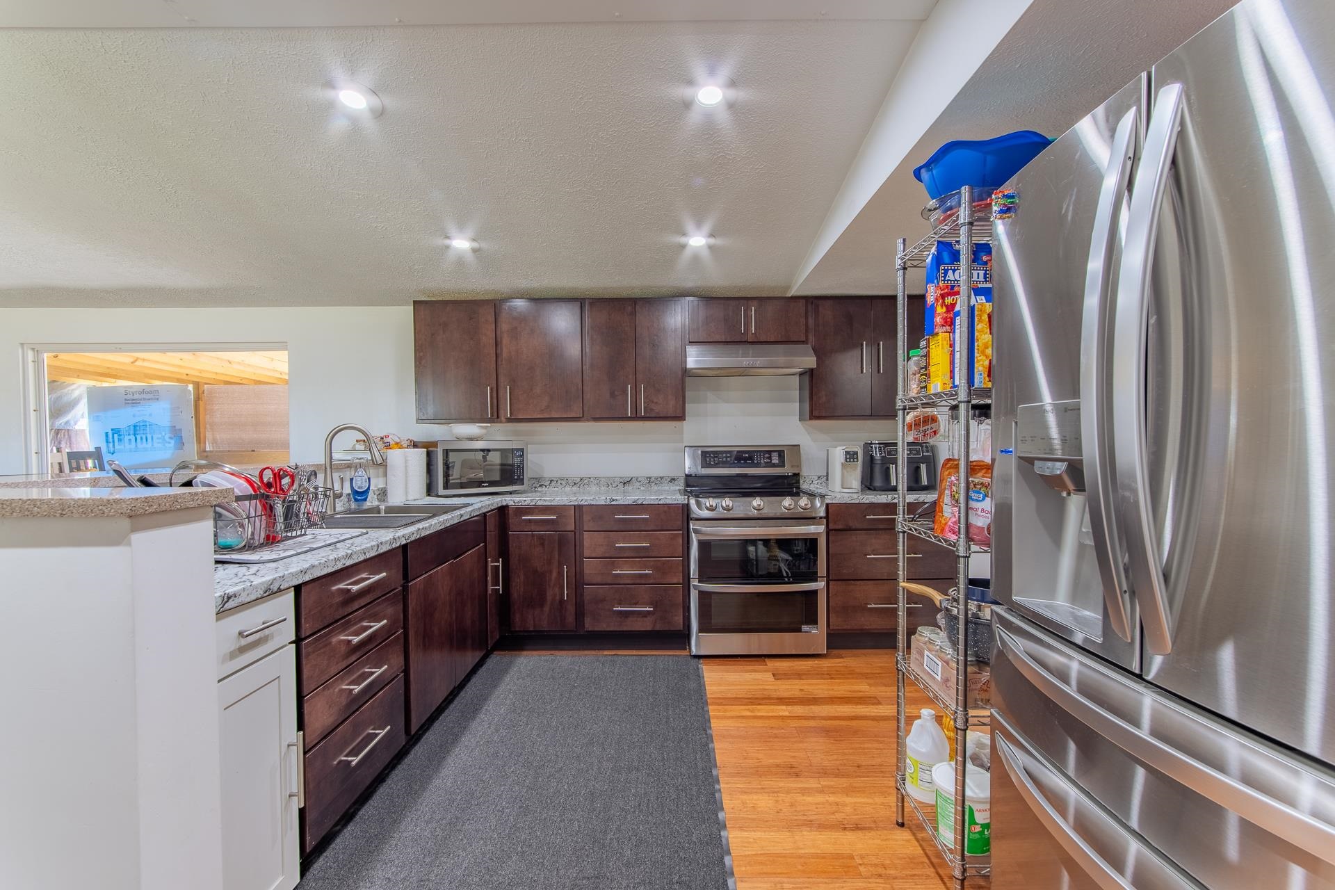 1670 Rose Creek Road Selmer, TN 38375 - Photo 36 of 40 a kitchen with stainless steel appliances granite countertop a refrigerator and a stove top oven
