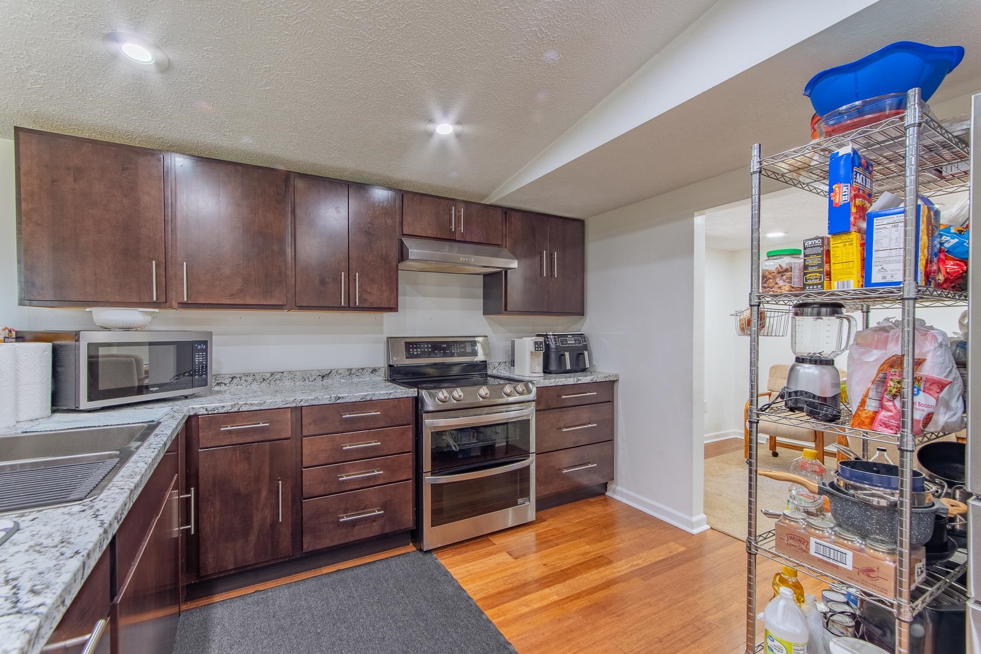1670 Rose Creek Road Selmer, TN 38375 - Photo 37 of 40 a kitchen with stainless steel appliances granite countertop a stove and a sink