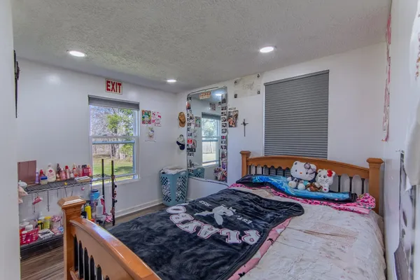 a backyard of a house with large trees and outdoor space