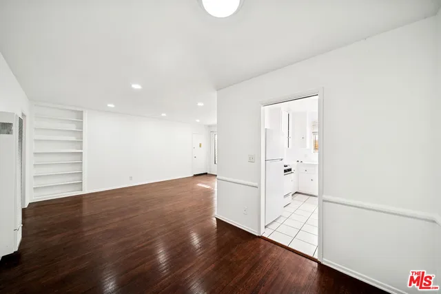 a view of an empty room and wooden floor