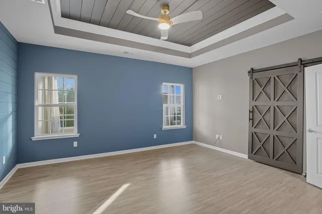 a view of an empty room with window and fire place