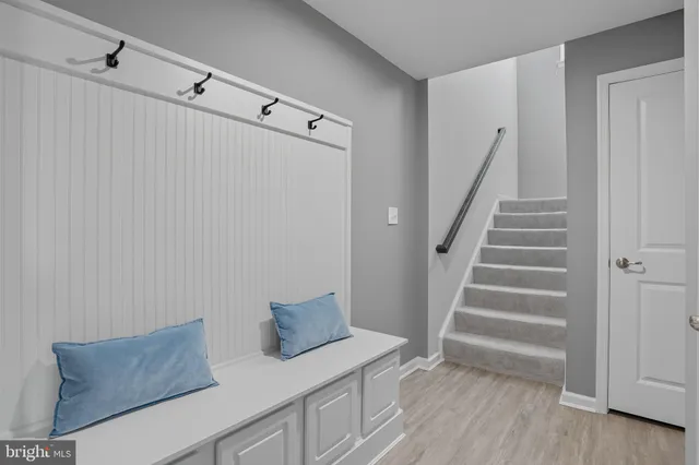 a view of room with stairs and wooden floor