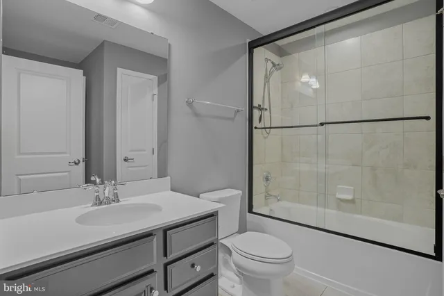 a bathroom with a sink toilet a mirror and shower