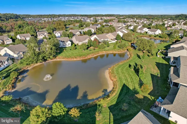 an aerial view of a residential houses with outdoor space and street view