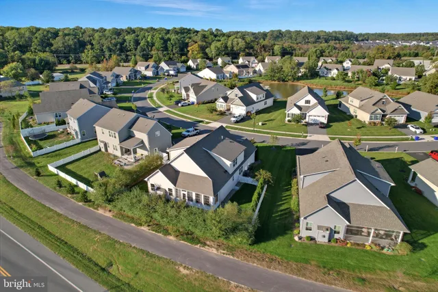 an aerial view of a house with a garden and lake view
