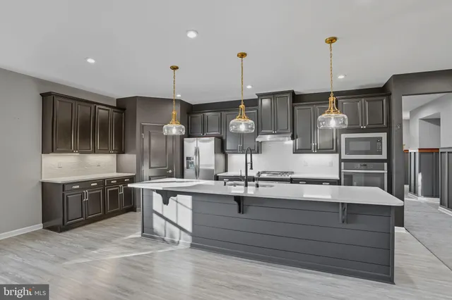 a kitchen with stainless steel appliances granite countertop a sink and stove