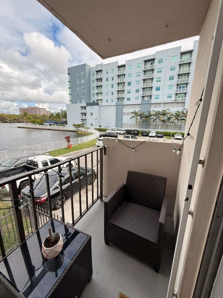 5501 Northwest 7th Street, Unit E207 Miami, FL 33126 - Photo 1 of 13 a view of a balcony with furniture