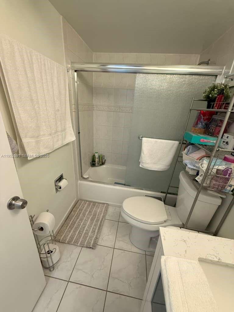 5501 Northwest 7th Street, Unit E207 Miami, FL 33126 - Photo 11 of 13 a bathroom with a toilet and a shower