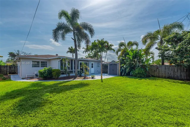 a view of a house with a yard and sitting area
