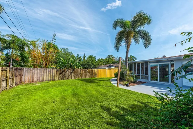a view of a house with a yard and sitting area