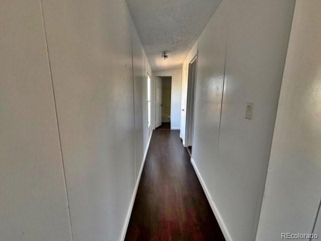 1211 Reed Lane La Junta, CO 81050 - Photo 12 of 17 a view of a hallway with wooden floor