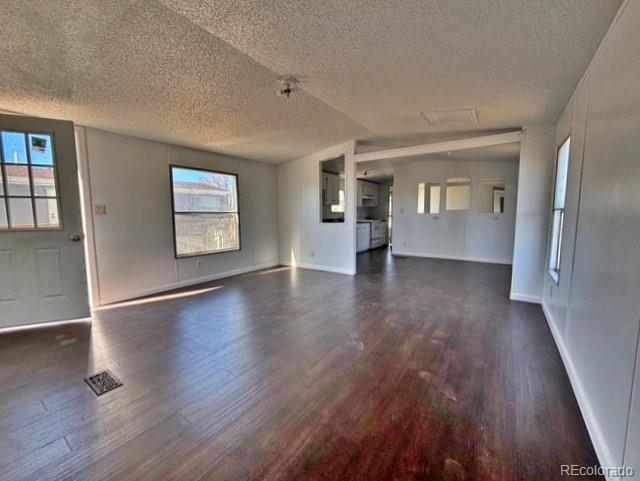 1211 Reed Lane La Junta, CO 81050 - Photo 4 of 17 an empty room with wooden floor and windows