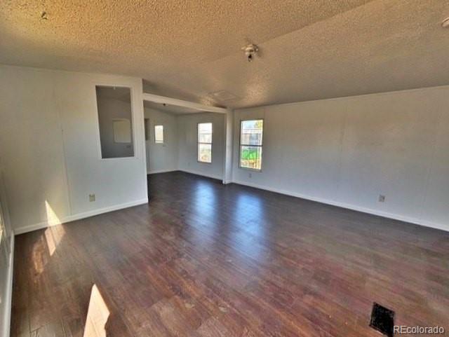 1211 Reed Lane La Junta, CO 81050 - Photo 8 of 17 a view of an empty room with window and wooden floor