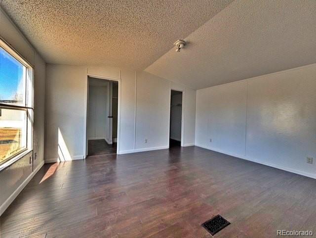 1211 Reed Lane La Junta, CO 81050 - Photo 10 of 17 an empty room with wooden floor and windows