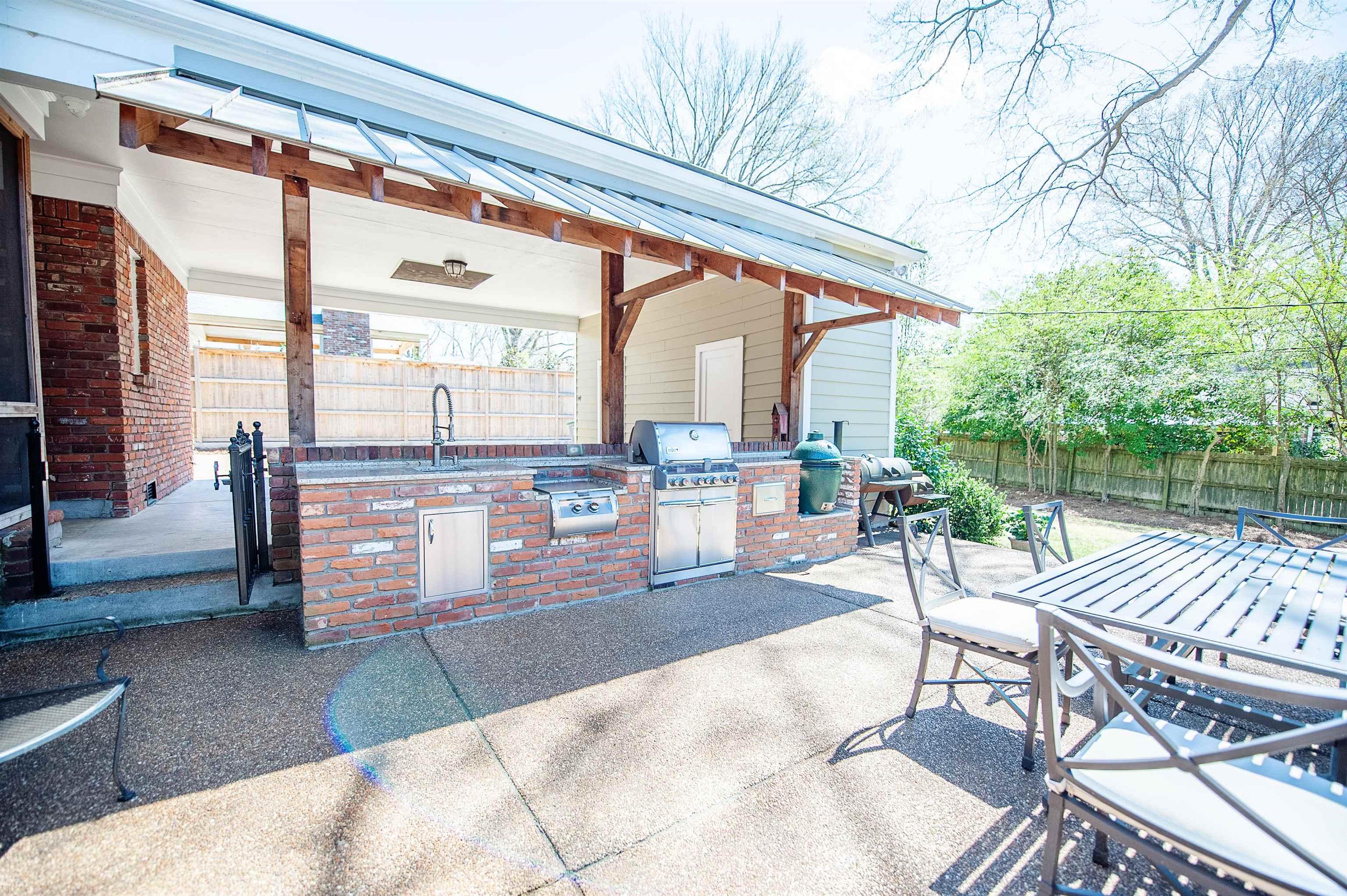 5431 South Angela Road Memphis, TN 38120 - Photo 22 of 25 a view of a patio with a table chairs and a patio