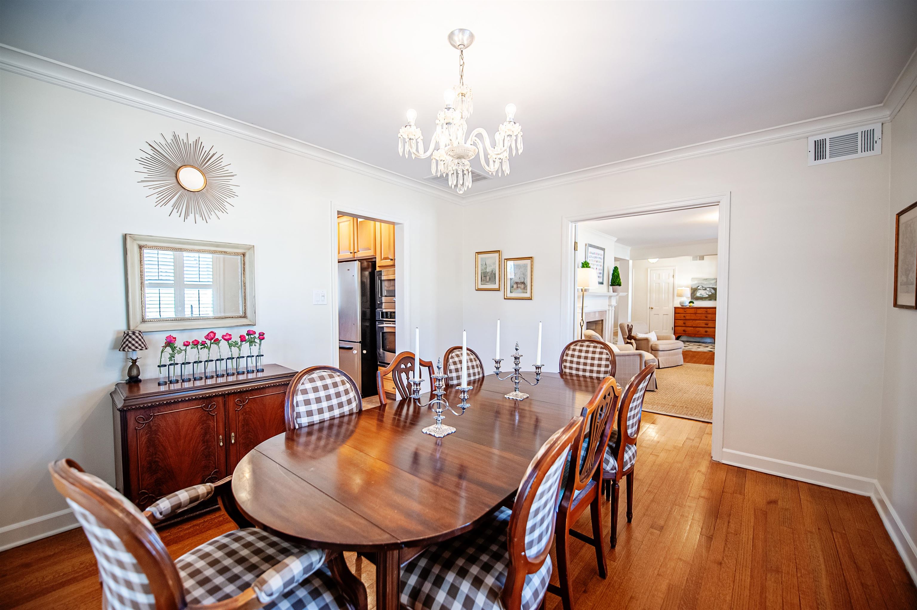 5431 South Angela Road Memphis, TN 38120 - Photo 5 of 25 a dining room with furniture a chandelier and wooden floor