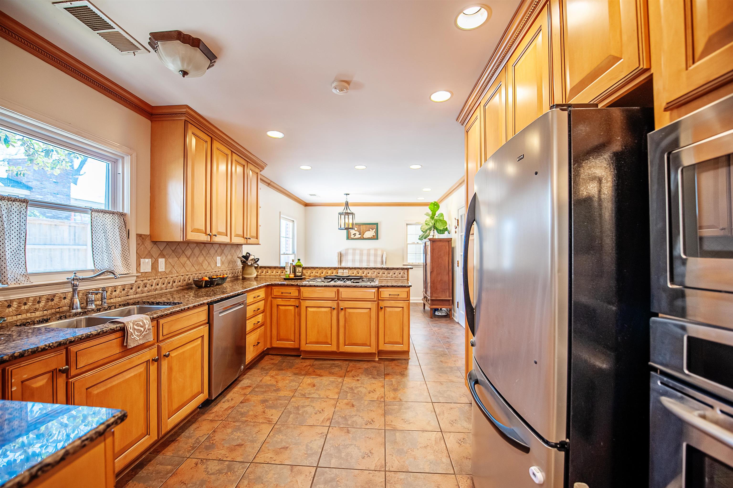 5431 South Angela Road Memphis, TN 38120 - Photo 7 of 25 a large kitchen with stainless steel appliances granite countertop a refrigerator and a sink