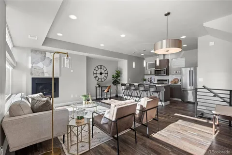a living room with lots of furniture and kitchen view